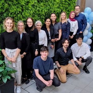 Twelve people pose for a photo.